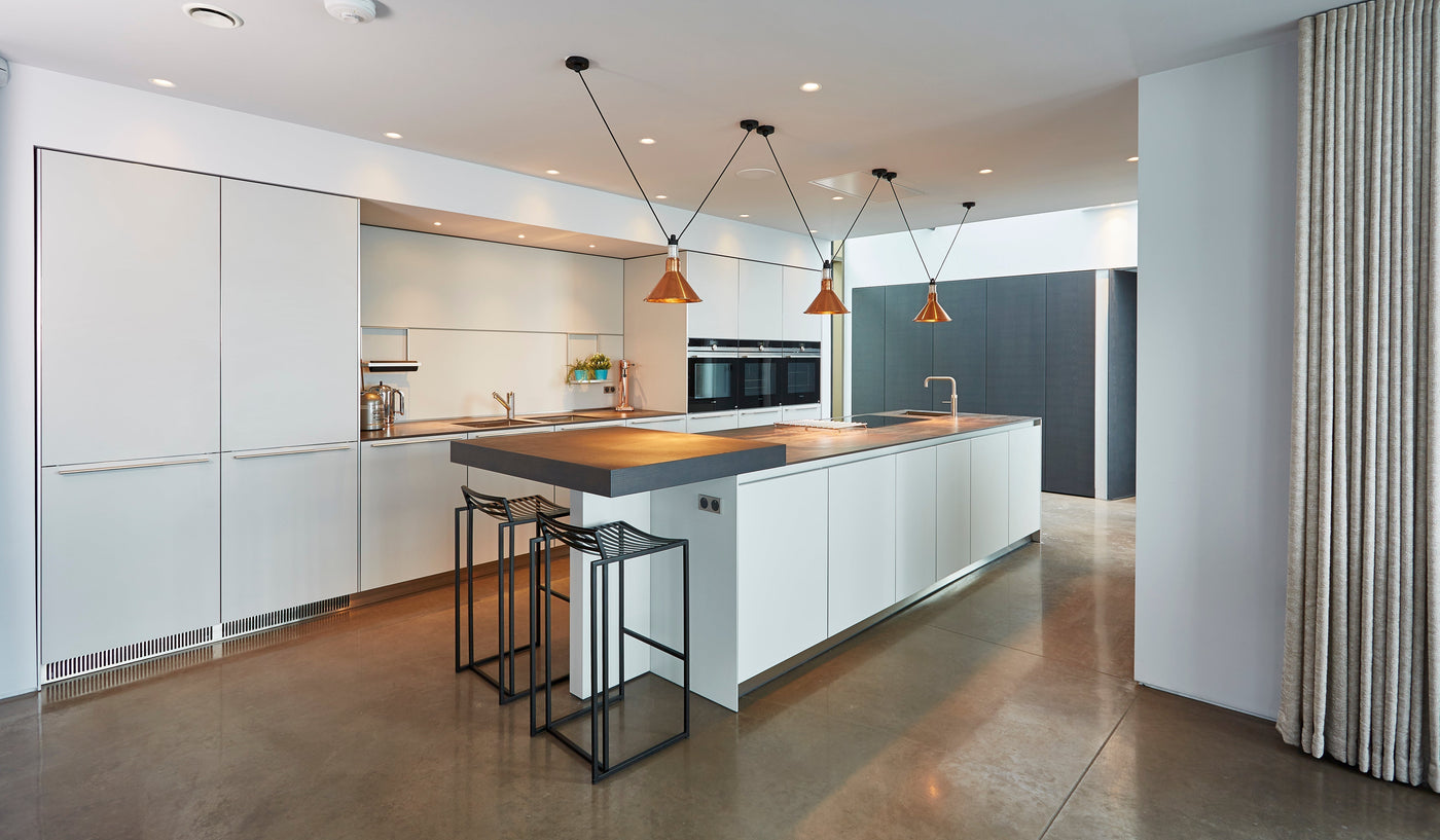 Modern open-plan kitchen featuring a central island with statement pendant lighting, under-cabinet LEDs, and natural wood accents for a warm, functional design