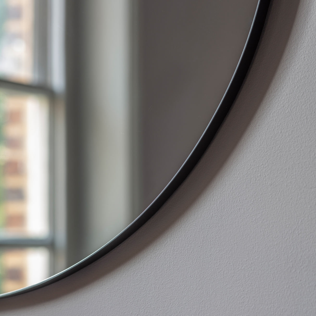 Amos Matt black round mirror – from Amos Lighting + Home