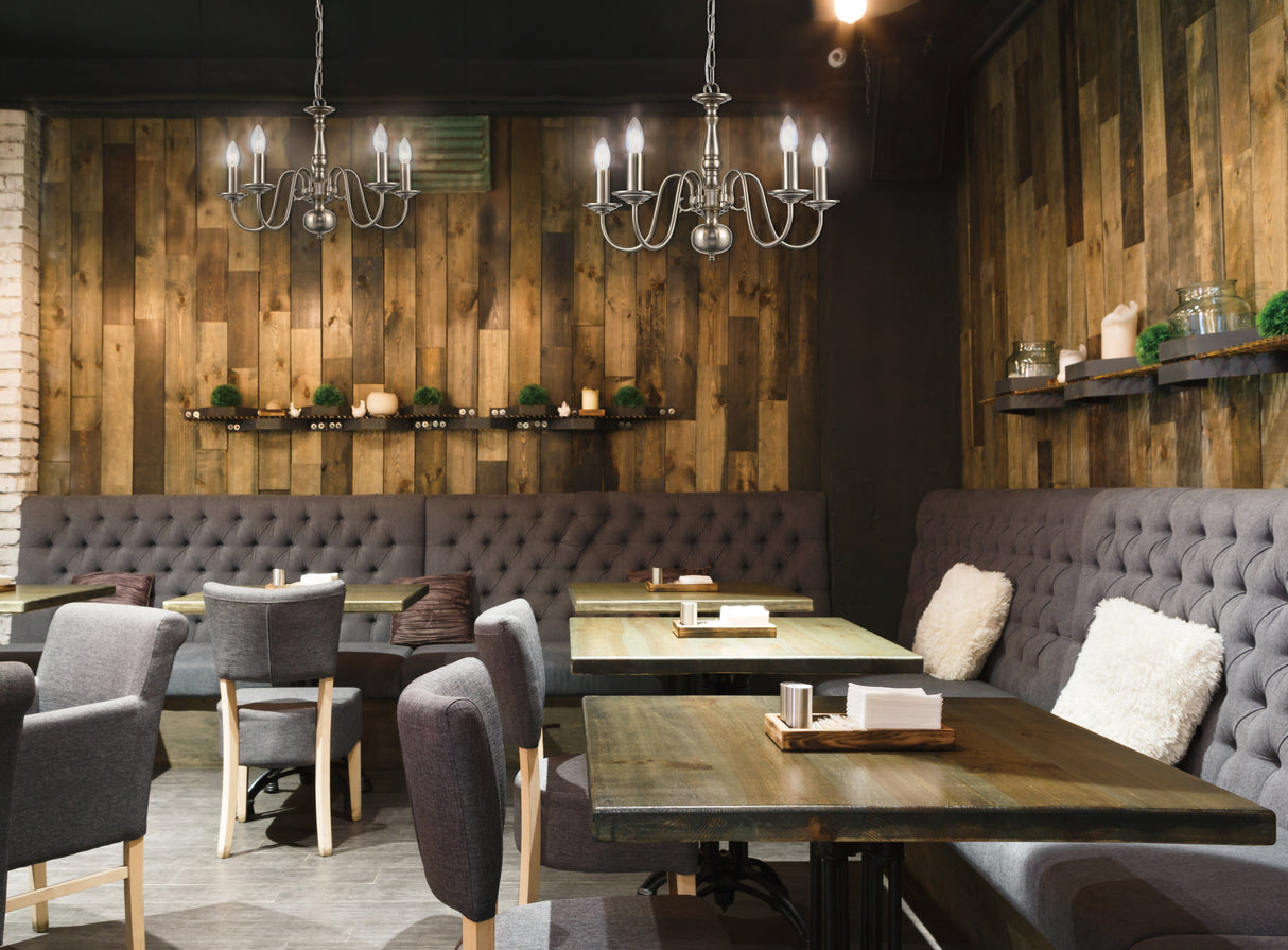 Cozy modern restaurant interior with wooden walls, gray upholstered seating, and chandeliers