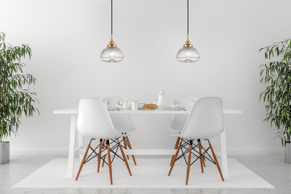 Minimalist white dining table set with croissants, eggs, and pendant lights in bright room