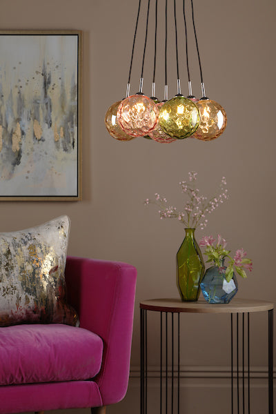 Dar Elpis 7-light cluster pendant with mixed glass shades above side table with vases in stylish living room