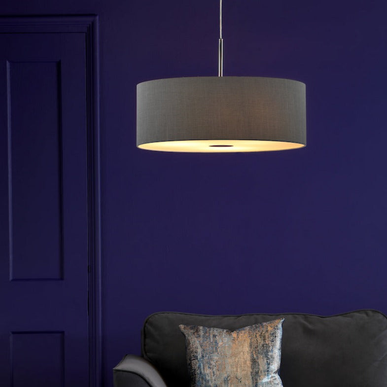 Dar Ronda 60cm slate grey fabric pendant light above dark sofa with patterned cushion against deep purple wall