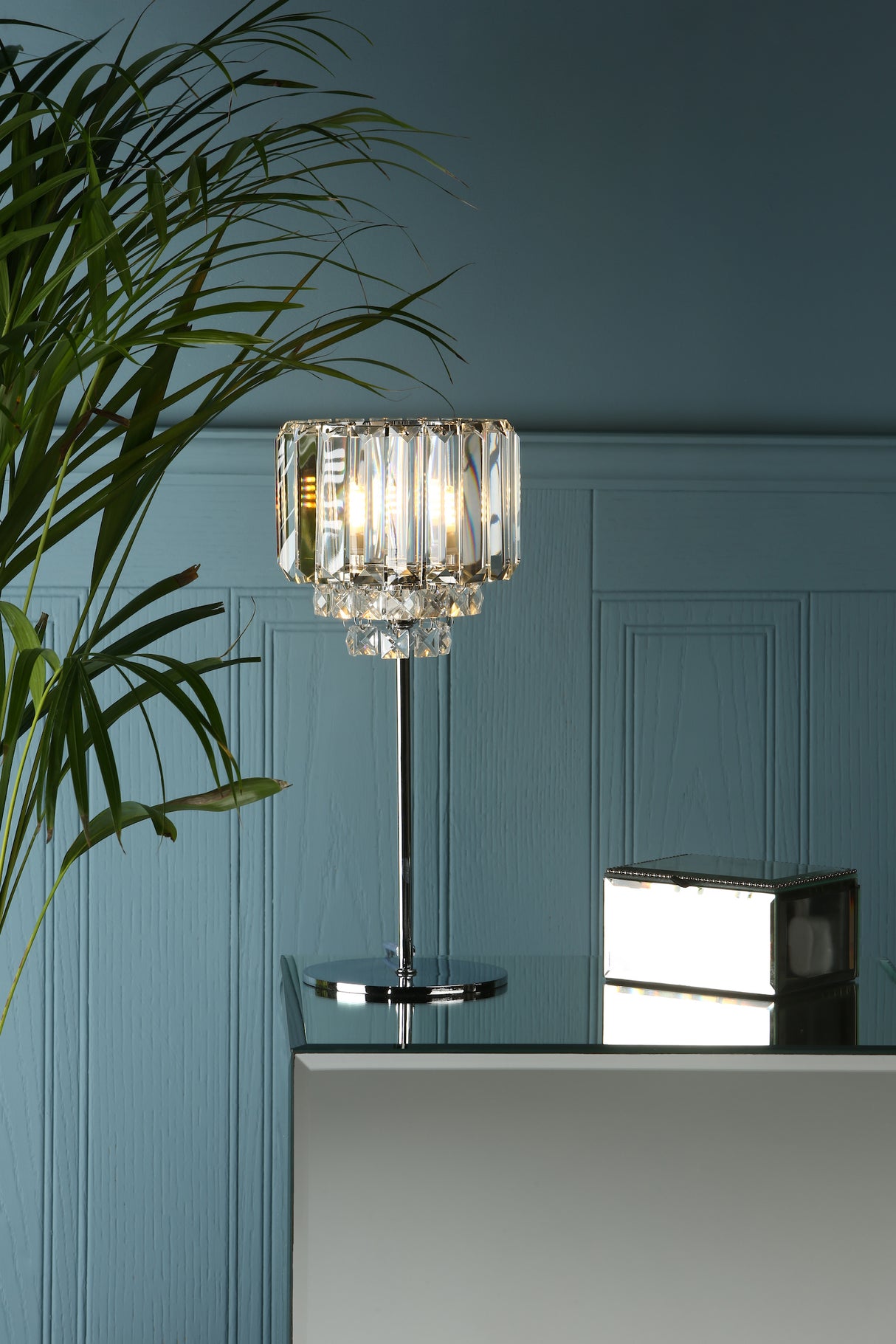 A Laura Ashley Vienna table lamp with crystal and polished chrome finish, featuring bevelled glass rods and a central fountain of square-cut glass droplets, mounted on a double circular frame with a round base.