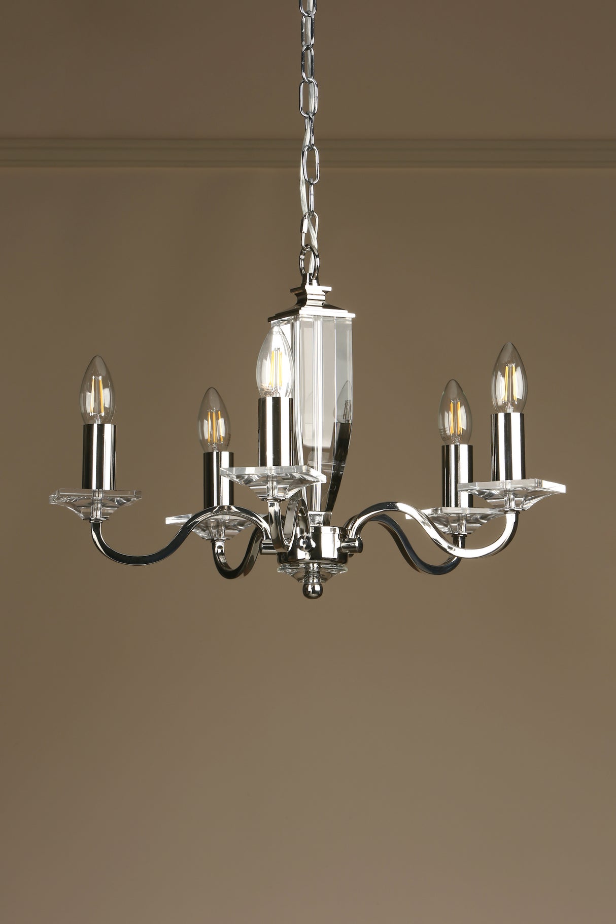Modern silver metal chandelier with five candle-style LED bulbs and clear glass accents