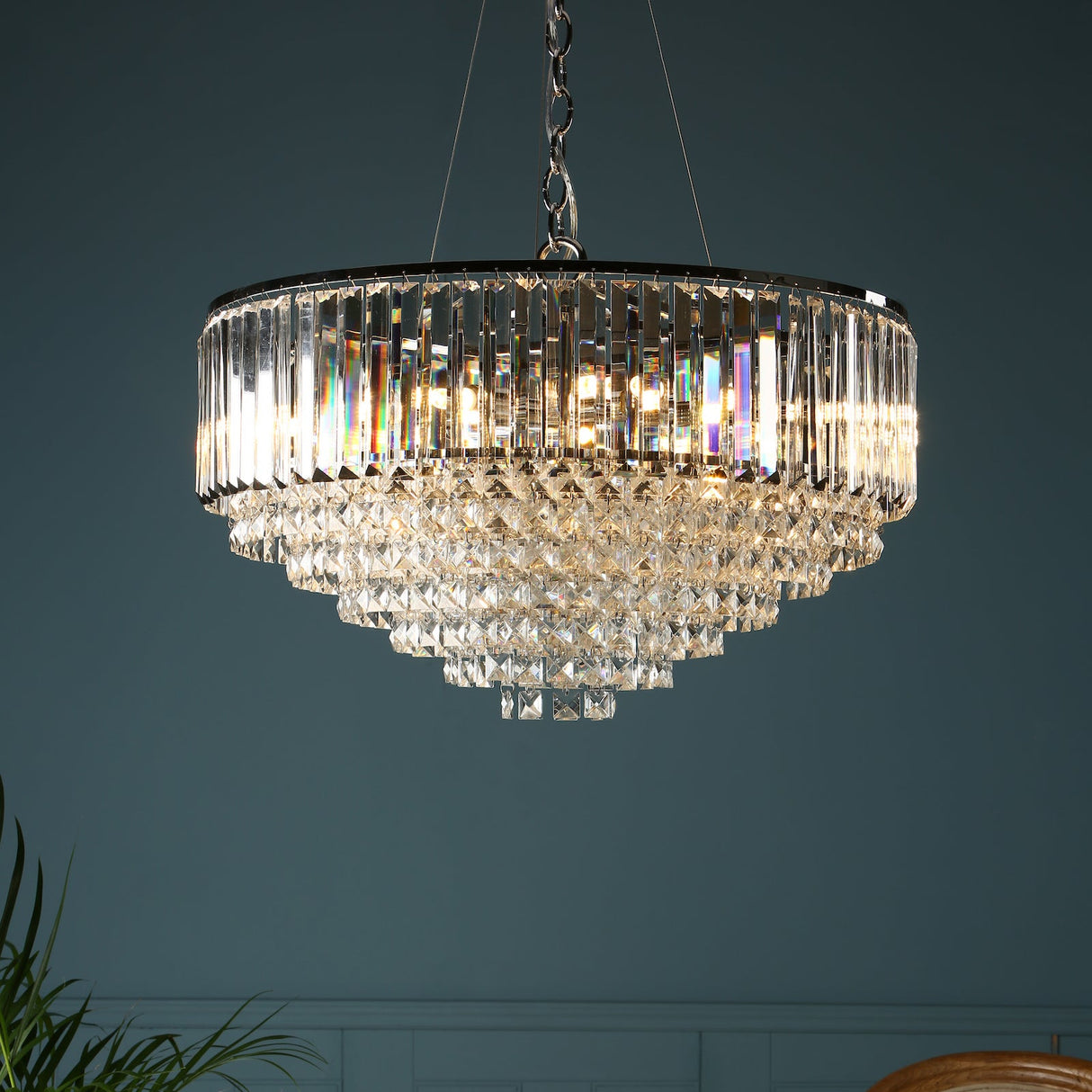 A luxurious Laura Ashley Vienna 9 light chandelier with polished chrome finish and bevelled glass crystal rods, displayed against a dark wall.