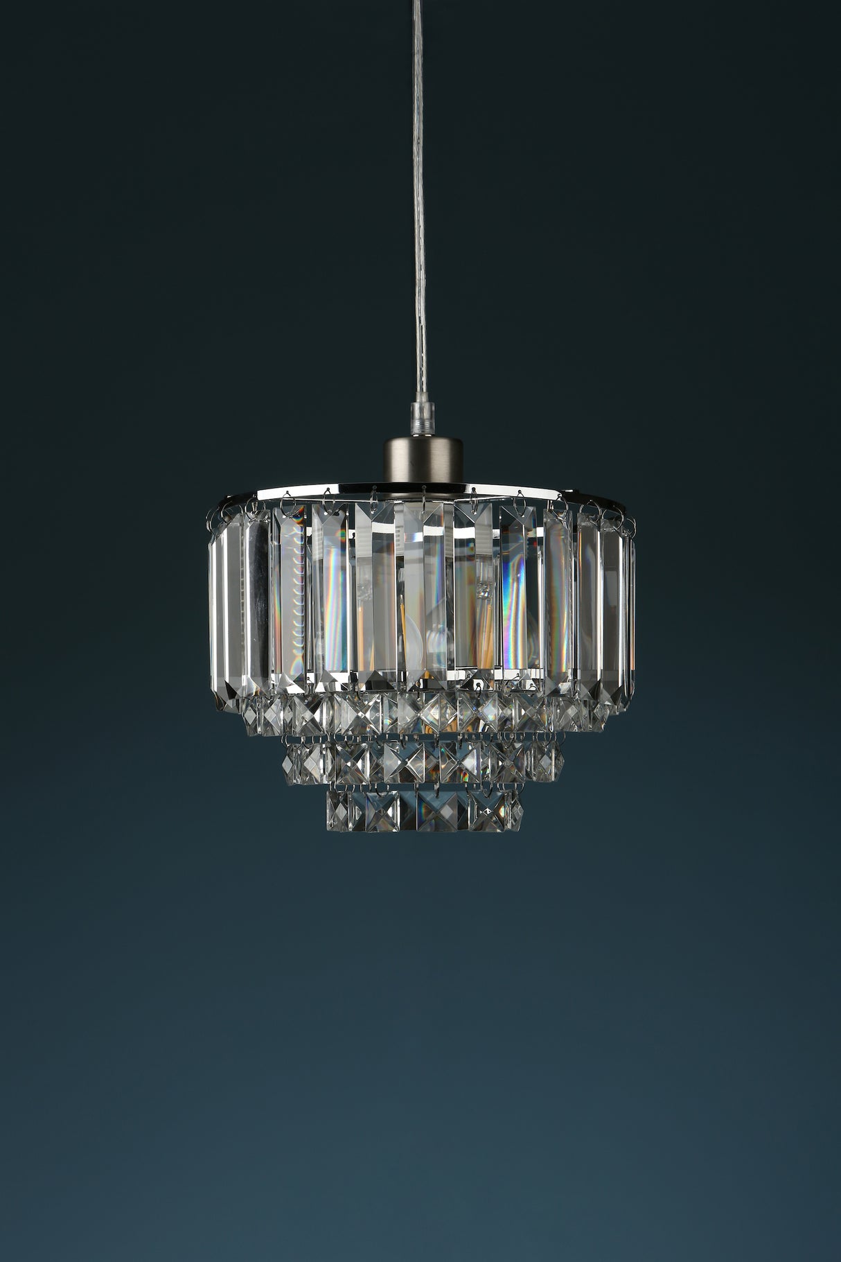 Modern crystal pendant light fixture with rectangular prisms and layered glass design on dark background