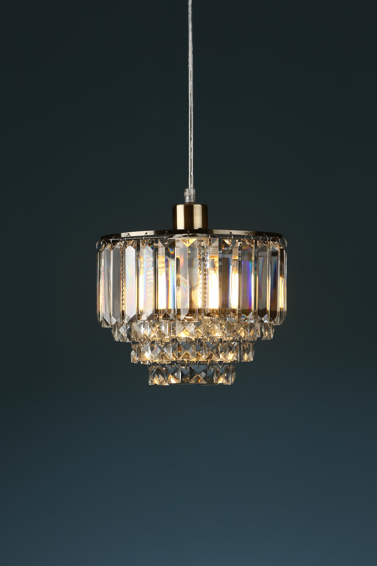 A Laura Ashley Vienna easy-fit pendant lampshade featuring bevelled glass crystals and antique brass finish, suspended against a dark background.