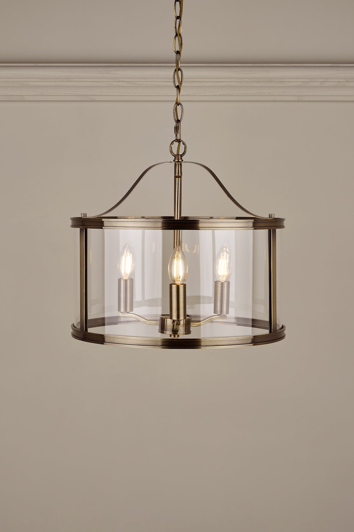 A Laura Ashley Harrington 3 Light Pendant Lantern with clear glass and antique brass finish.