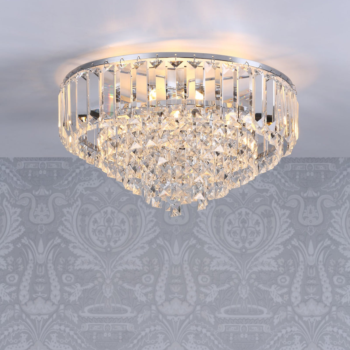 A Laura Ashley Vienna 3 Light Flush Crystal and Polished Chrome ceiling light fixture, with bevelled glass rods and square-cut faceted glass droplets, suspended from a circular frame.