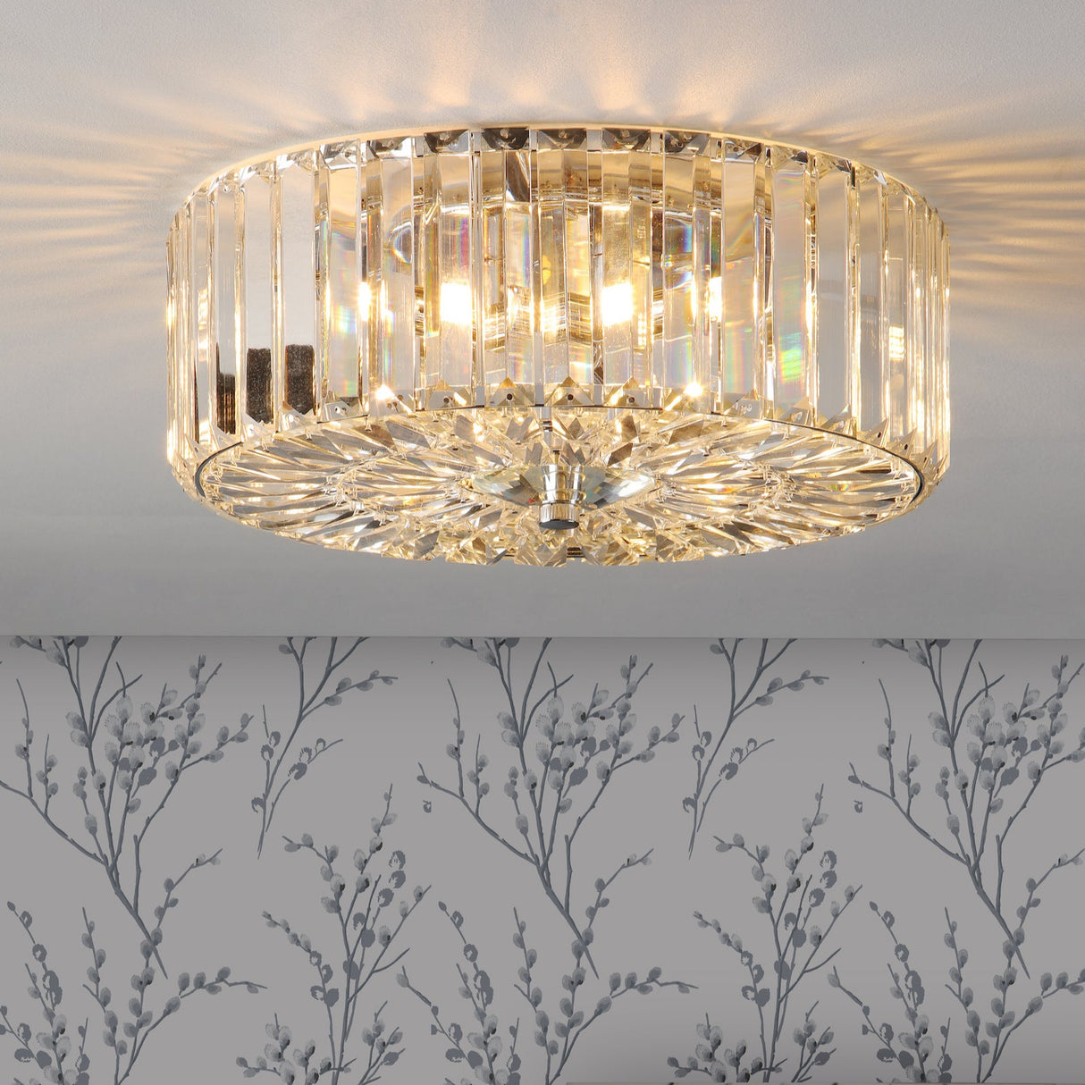 Crystal flush mount ceiling light with elegant prism design glowing on white ceiling