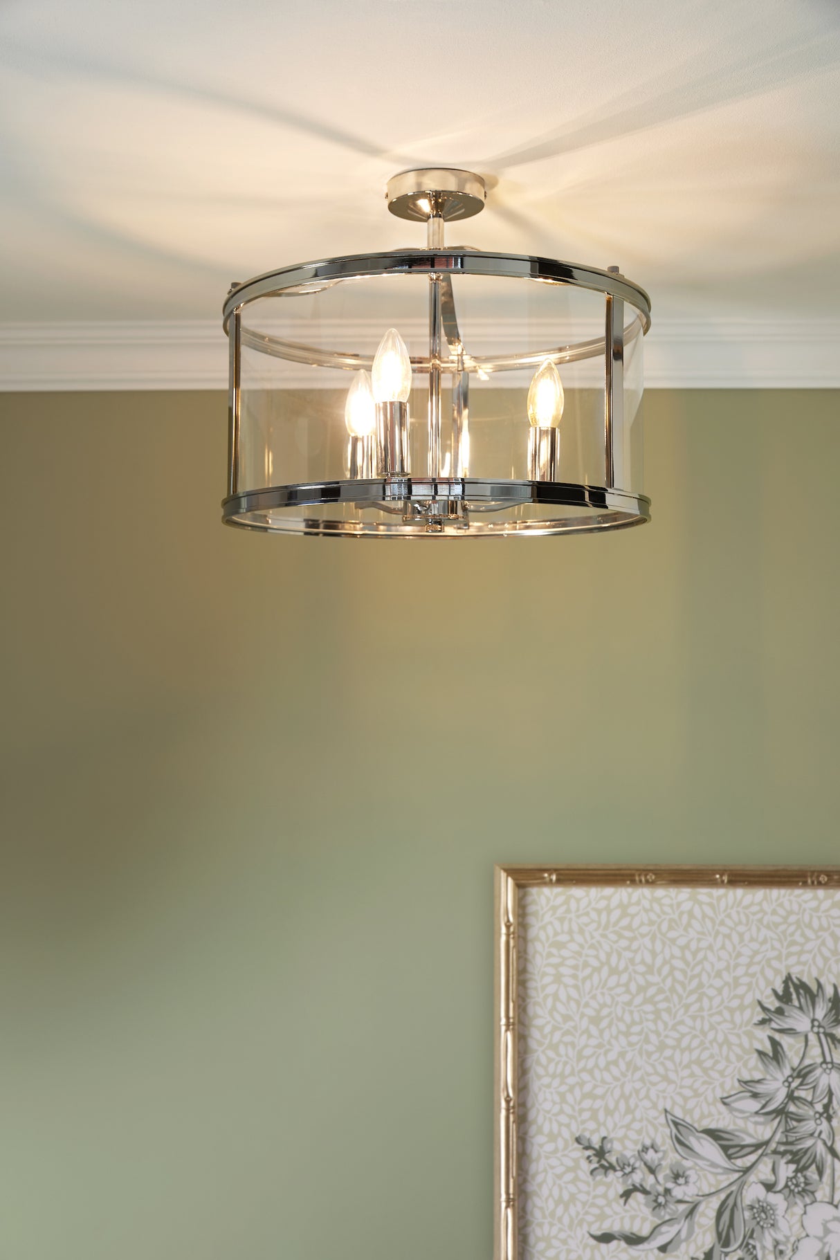 Modern chrome and glass semi-flush ceiling light with exposed bulbs in beige room