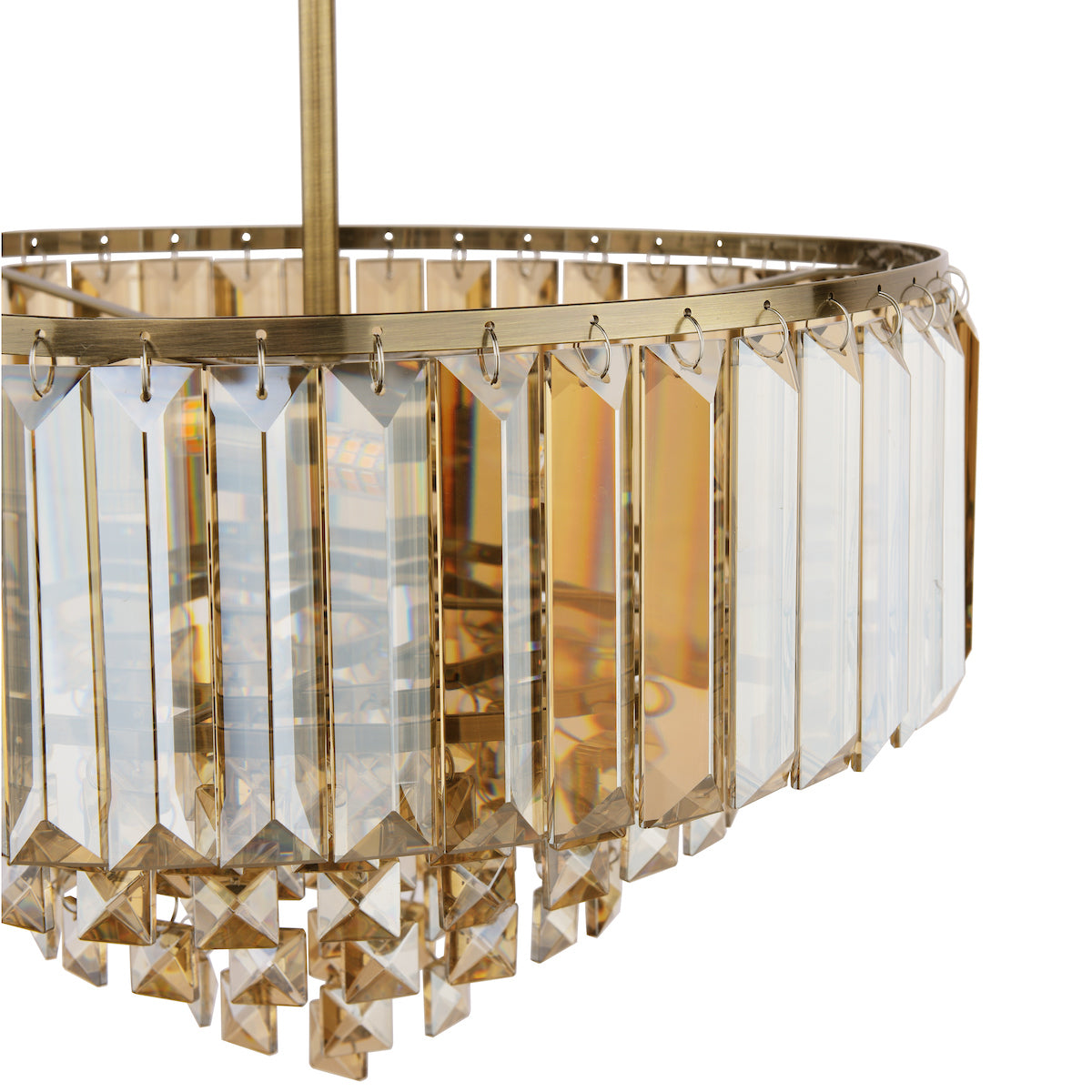 Close-up of gold metal chandelier with hanging clear and amber crystal prisms