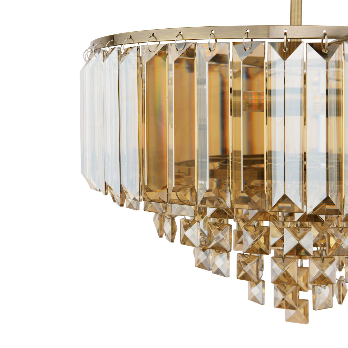 Close-up of a layered crystal chandelier with rectangular and square golden glass prisms