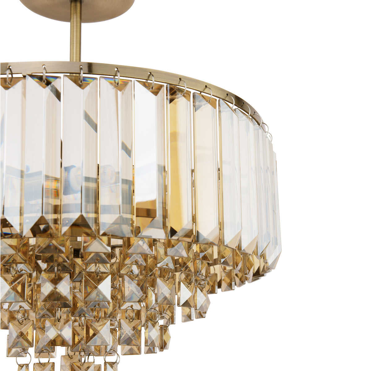 Close-up of a modern chandelier with clear rectangular and square crystals on gold metal frame