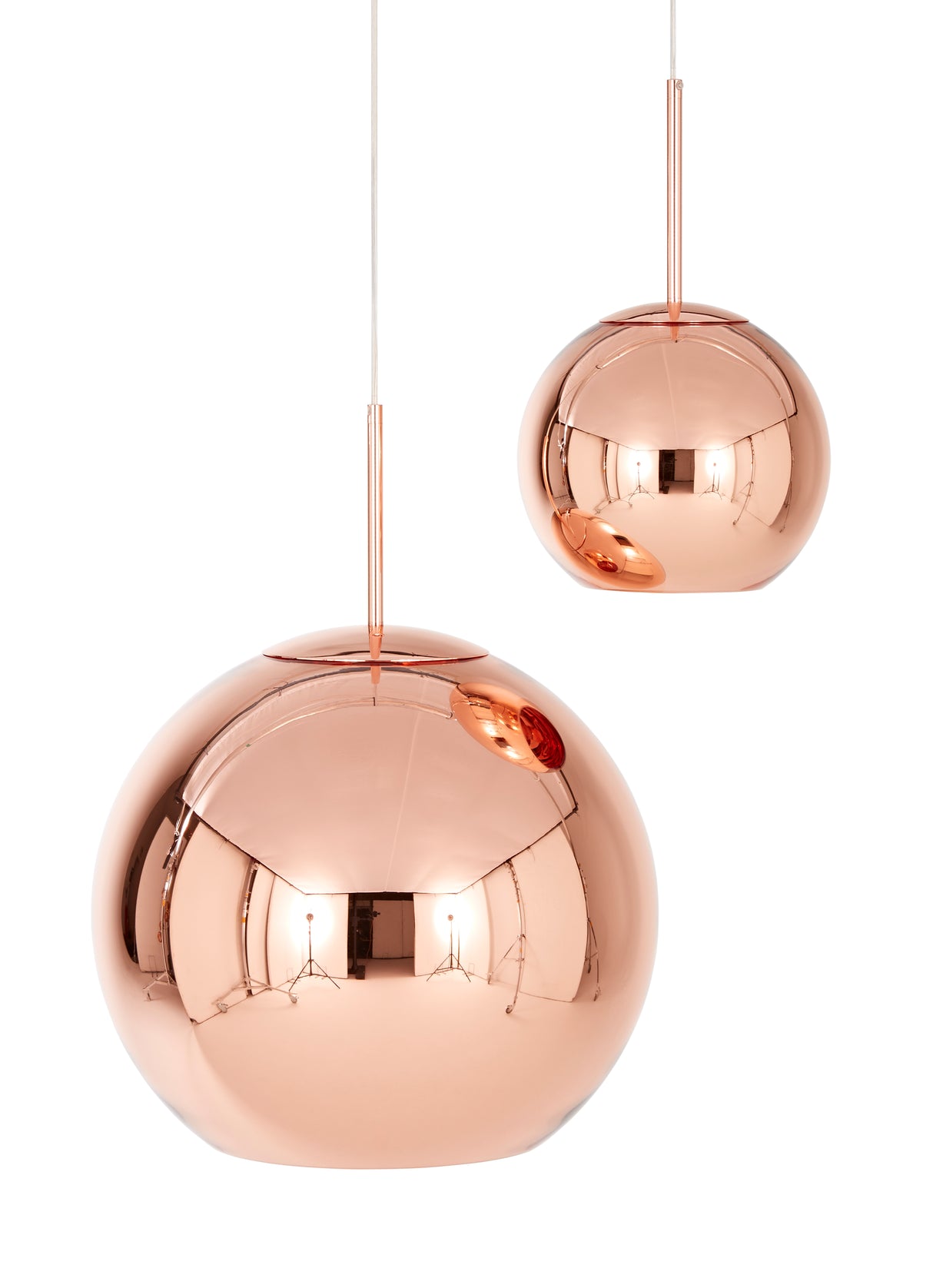 Pair of modern copper pendant lights with reflective round shades hanging by cords