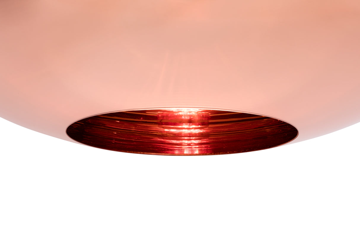 Close-up of modern pendant light with white exterior and copper reflective interior