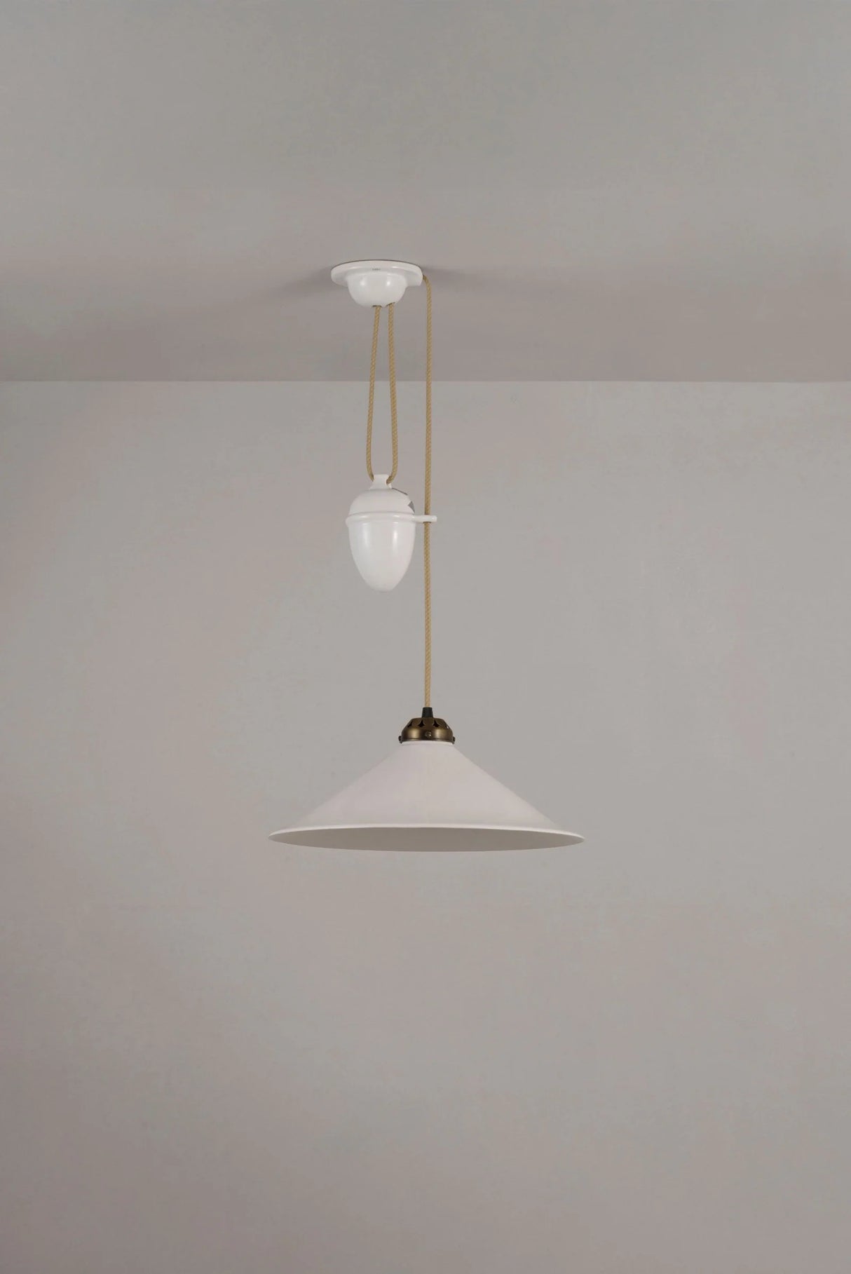 Original BTC Cobb Rise and Fall. Two pendant lights hanging from a ceiling against a plain wall.