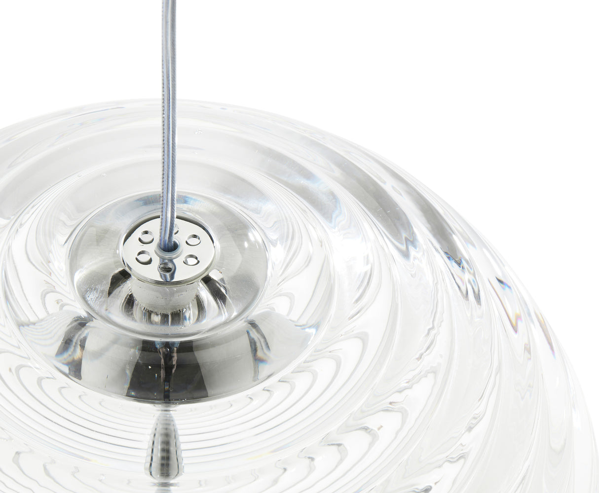 Close-up of transparent glass pendant light with metal cable fixture on white background