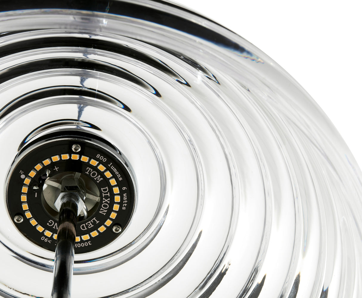 Close-up of Tom Dixon LED lighting component inside a transparent ribbed glass pendant lamp