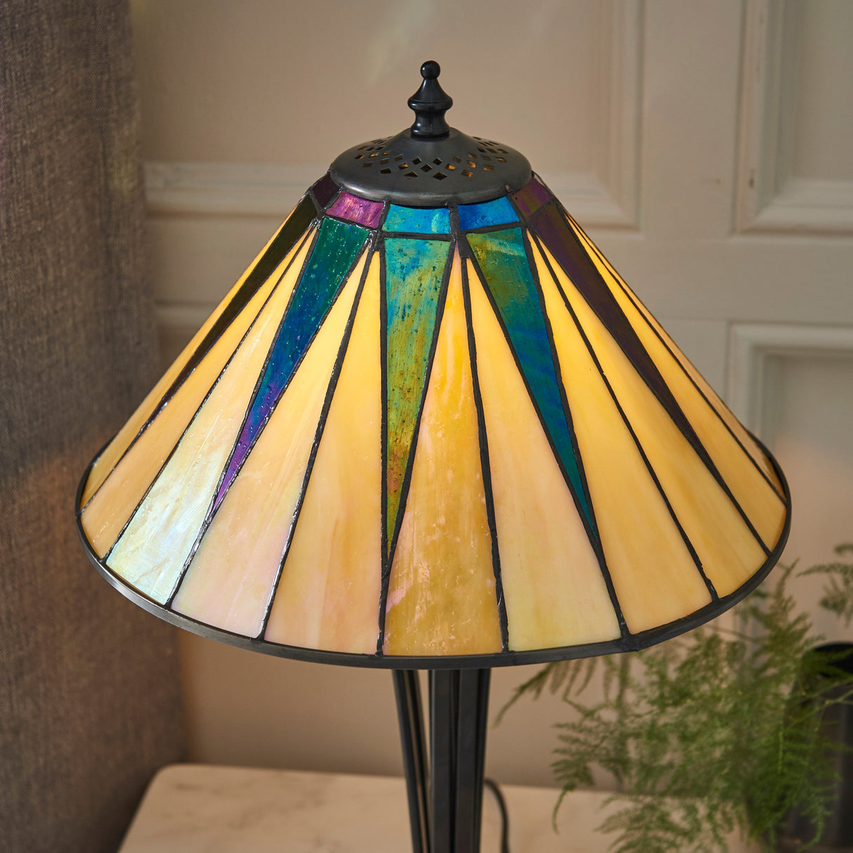Tiffany-style dark star stained glass table lamp with blue and yellow panels on a black stand