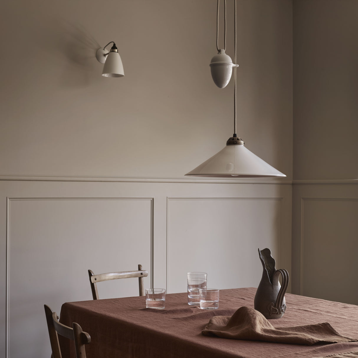 Dining room with a table, chairs, and a pendant light fixture.