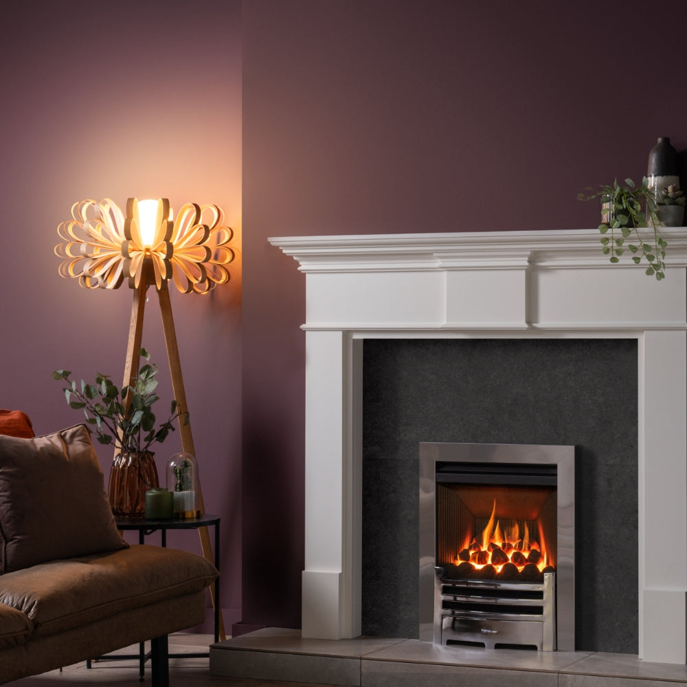 Modern living room with wooden loopie floor lamp beside lit fireplace and brown leather sofa