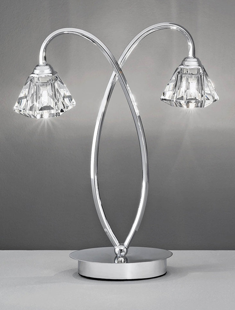 Modern double-light table lamp with curved chrome arms and crystal shades on silver base