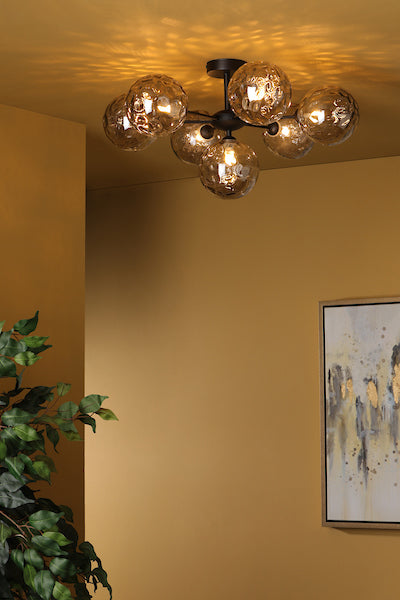 Modern 7-light semi-flush ceiling fixture with matt black metal and smoked glass globes in warm-toned room
