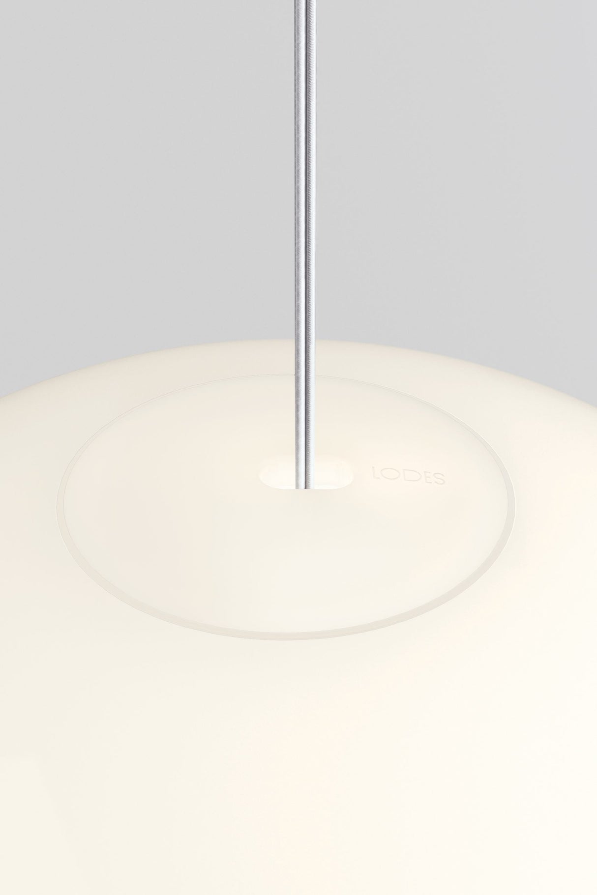 Close-up of modern Lodes Volum 42 pendant suspension light with white frosted glass shade and metal rod
