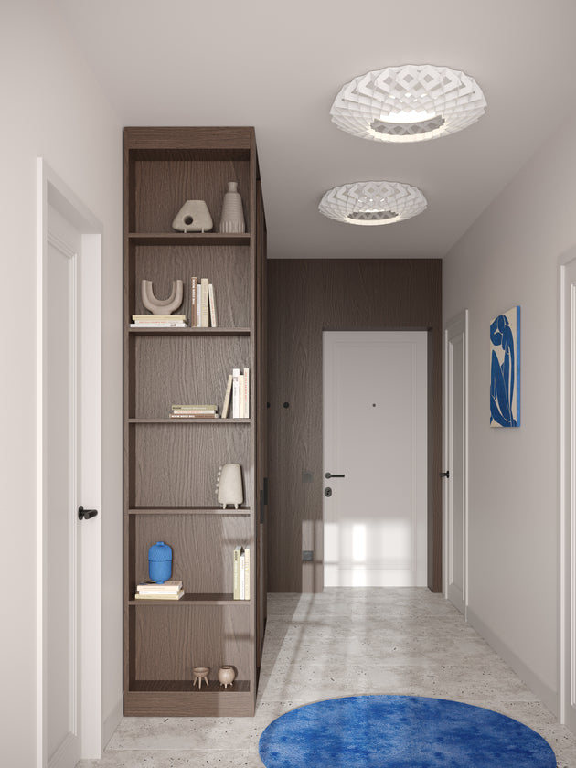Modern hallway with white Pilke ceiling lights, wooden bookshelf, blue round rug, and minimalist decor