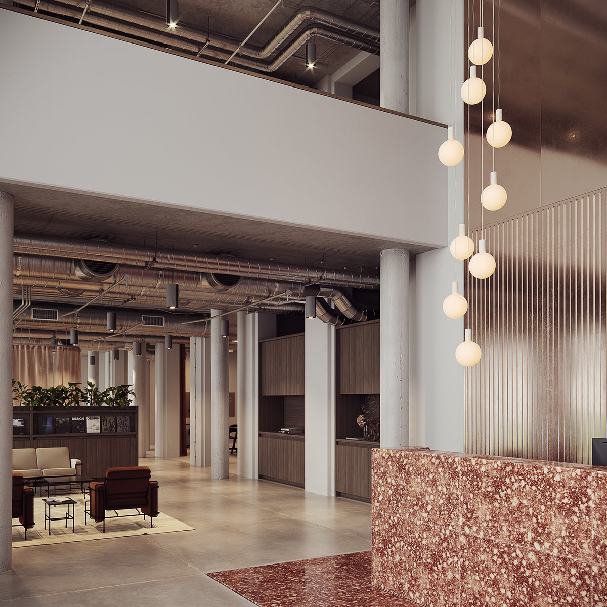 Modern office lobby with red terrazzo reception desk and hanging white globe pendant lights