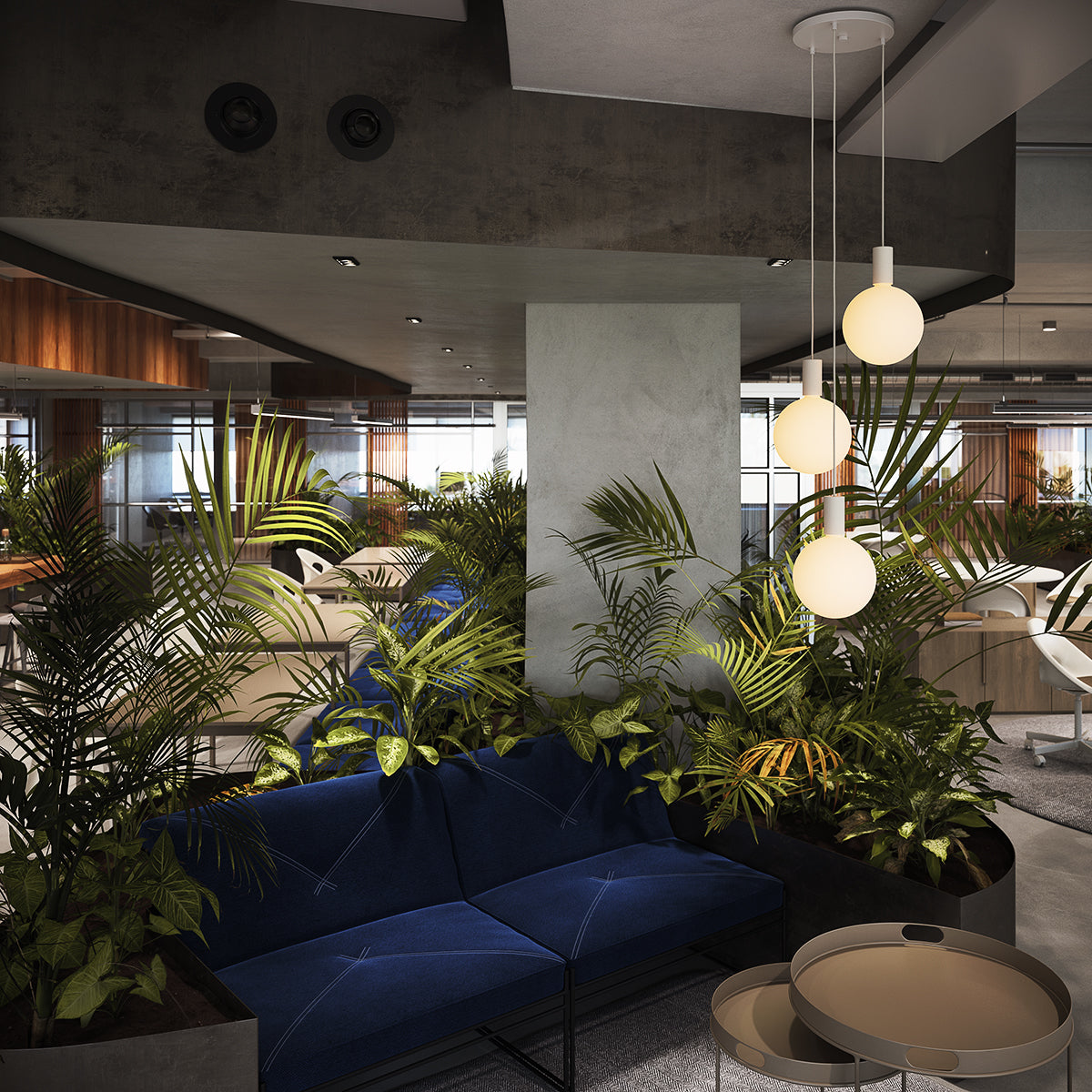 Modern office lounge with blue sofa, lush green plants, round pendant lights, and gray tables