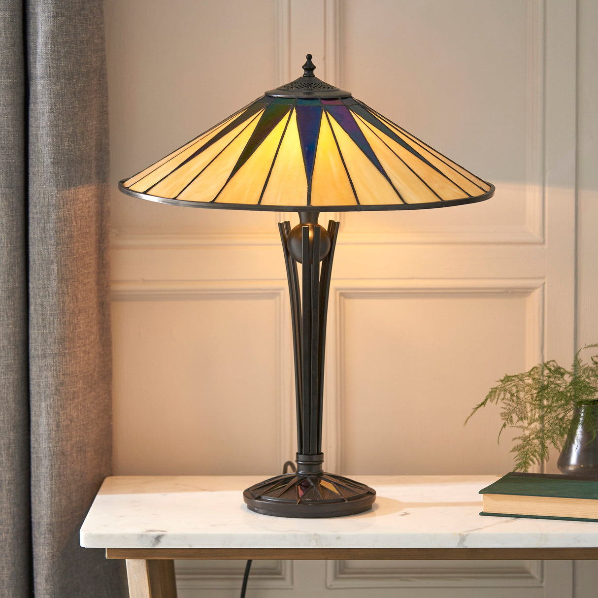 Tiffany dark star stained glass table lamp on marble top table in stylish room