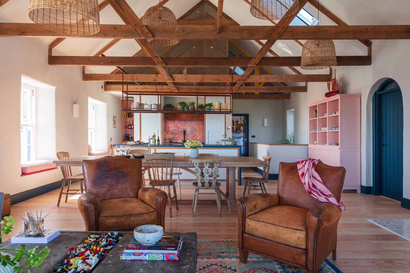 Open-plan kitchen with discreet LED tape lighting integrated into wooden cabinetry, highlighting craftsmanship and providing subtle task light.