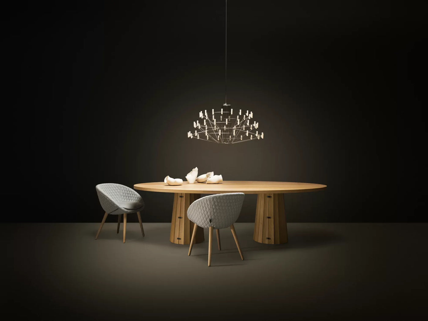A_beautiful_Moooi_Coppelia_suspended_chandelier adding luxury and warmth to a modern dining space