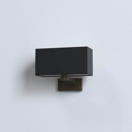 Modern black rectangular wall sconce light fixture with bronze base on white wall