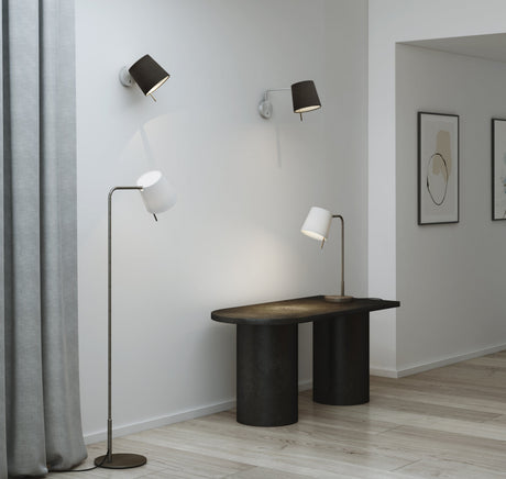Minimalist interior with black and white modern lamps on wall, floor, and black table