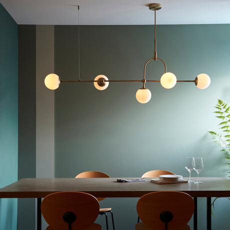 Modern dining room with wooden table, curved wood chairs, and six-light satin silver bar chandelier
