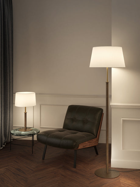 Cozy corner with black leather armchair, green marble side table, and two modern lamps