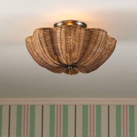 Wicker ceiling light fixture above a framed picture with striped wallpaper.