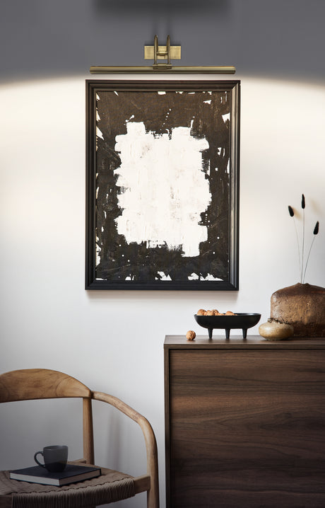 Modern interior with abstract black and white painting, wooden chair, and dark wood cabinet