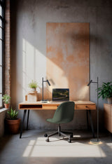 Modern home office with wooden desk, green swivel chair, laptop, black desk and floor lamps, and potted plants