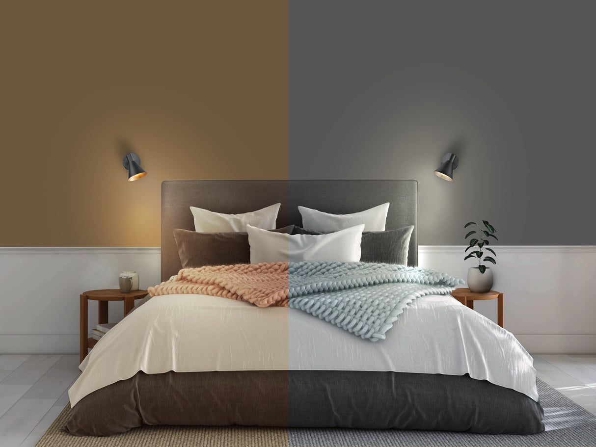 Modern bedroom with split lighting effect showing brown and gray walls, cozy bed with knitted blankets