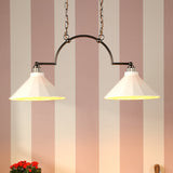 Two pendant lights hanging above a wooden shelf with decorative items against a striped wall.