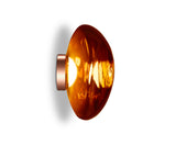 Side view of Melt Surface 50 LED wall light with amber glass and copper base on white background