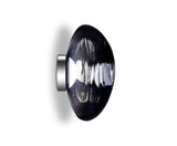 Side view of a modern wall sconce with a smoky glass shade and metallic base on white background