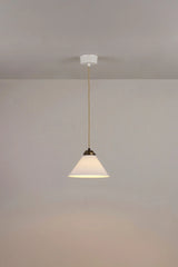 Original BTC Cobb Small. Pendant light fixture hanging from a ceiling against a plain wall.