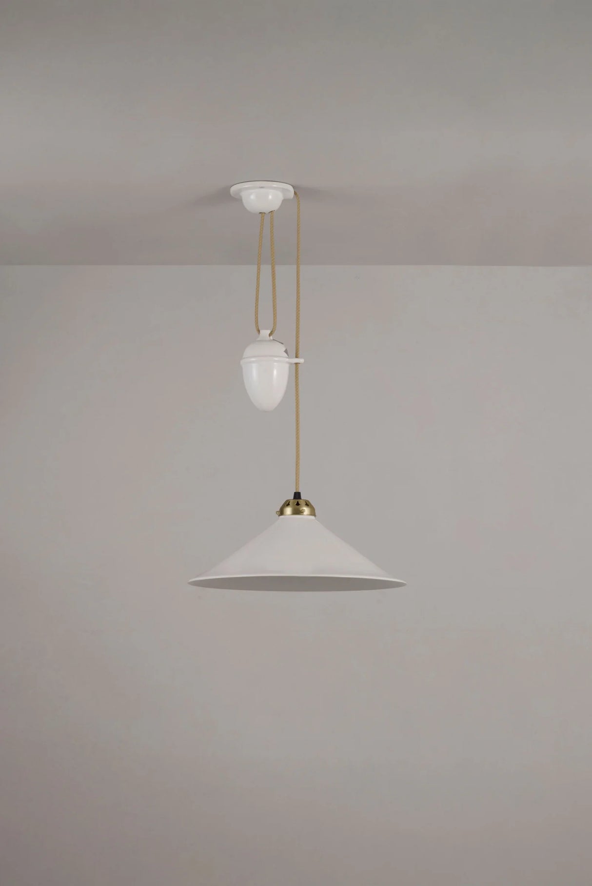 Modern pendant light with white shades and gold fixtures on a plain background