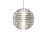 Modern clear glass pendant light with horizontal ridges, glowing softly on white background