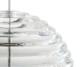 Close-up of a clear glass pendant light with concentric circular ridges and an LED bulb inside